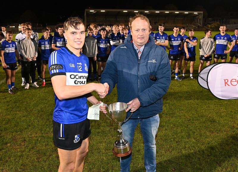 Peter Watson, the chairperson of Rebel Óg, presents the trophy to Sarsfields captain Harry Cogan. Picture: Eddie O'Hare Peter Watson, the chairperson of Rebel Óg, presents the trophy to Sarsfields captain Harry Cogan. Picture: Eddie O'Hare