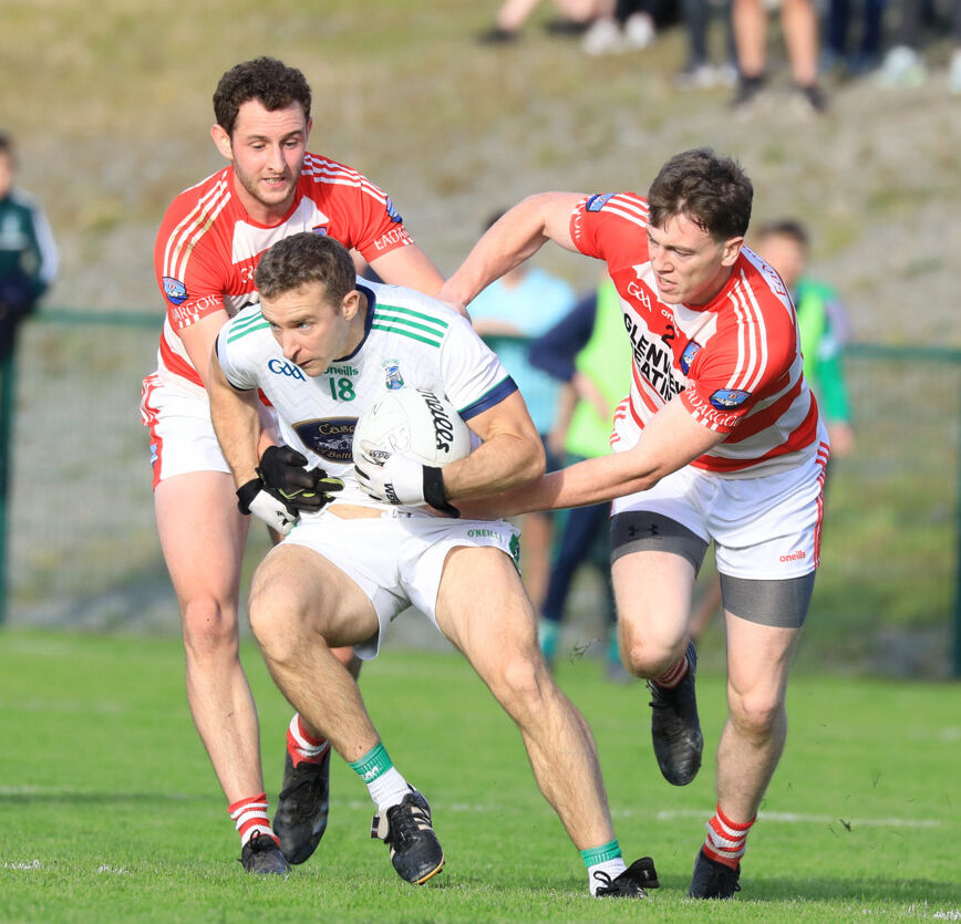 Feral Carey and Daniel Harrington tackle Ilen Rovers' Alan Holland. Picture: Anne Marie Cronin Photography Feral Carey and Daniel Harrington tackle Ilen Rovers' Alan Holland. Picture: Anne Marie Cronin Photography