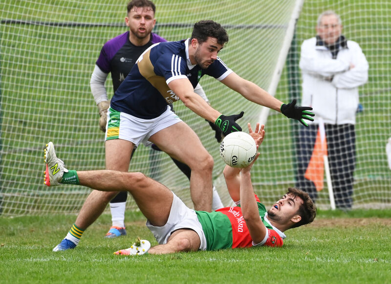  Ballinora's Ivan Quirke gets the ball off from Kilmurrys' John O'Mullane. Picture: Eddie O'Hare