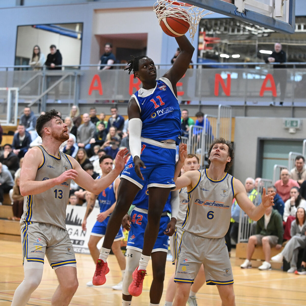 UCC Demons' Tala Fam Thiam scores a basket from Flexachem Killorglin's Jordan Blount and Andrew Fitzgerald. Picture: Eddie O'Hare