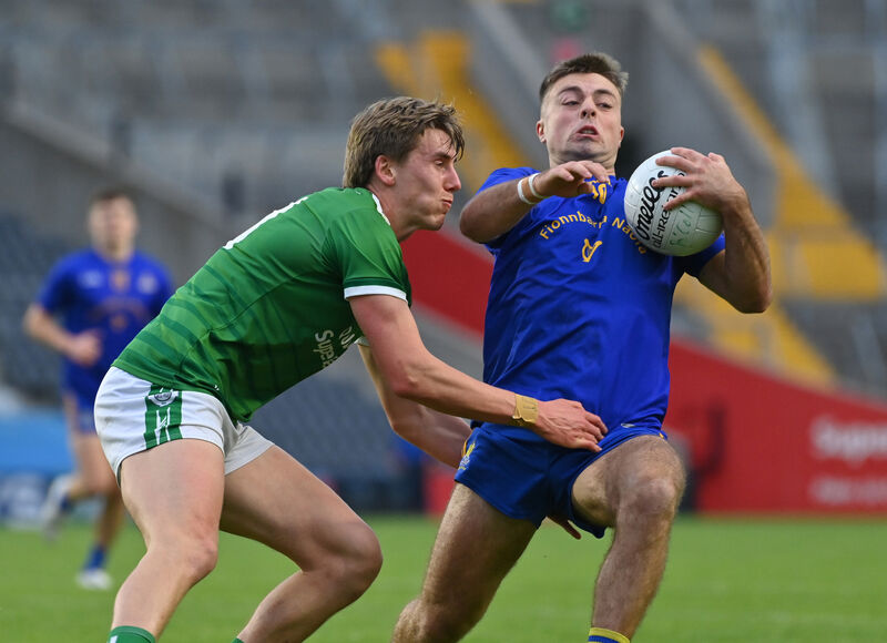  William Buckley of St Finbarr's is tackled by Liam O'Connell of Ballincollig. Picture: Dan Linehan