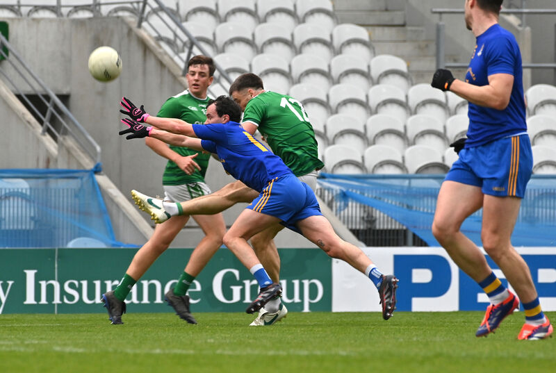  Conor Dennehy of St Finbarr's dives to stop this shot by Peter O'Neill of Ballincollig. Picture: Dan Linehan