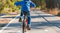 Kid riding his bicycle on bike lane