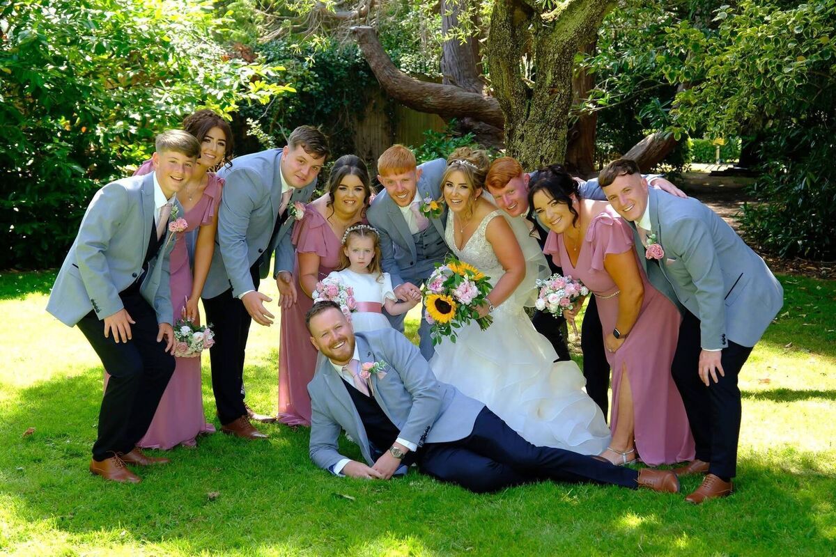 Katlyn and Alan pictured on their wedding day with their bridal party.