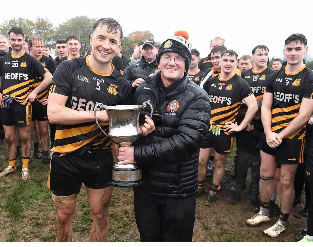Duhallow Junior Board secretary Liam Buckley presents the Duhallow Junior A Football Championship Cup to Castlemagner captain Conor Murphy. Picture: John Tarrant 