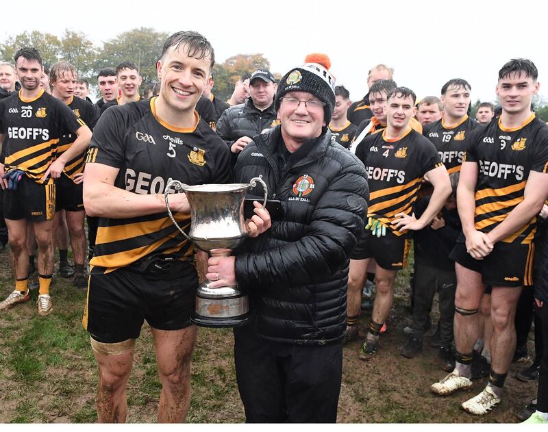 Duhallow Junior Board secretary Liam Buckley presents the Duhallow Junior A Football Championship Cup to Castlemagner captain Conor Murphy. Picture: John Tarrant 