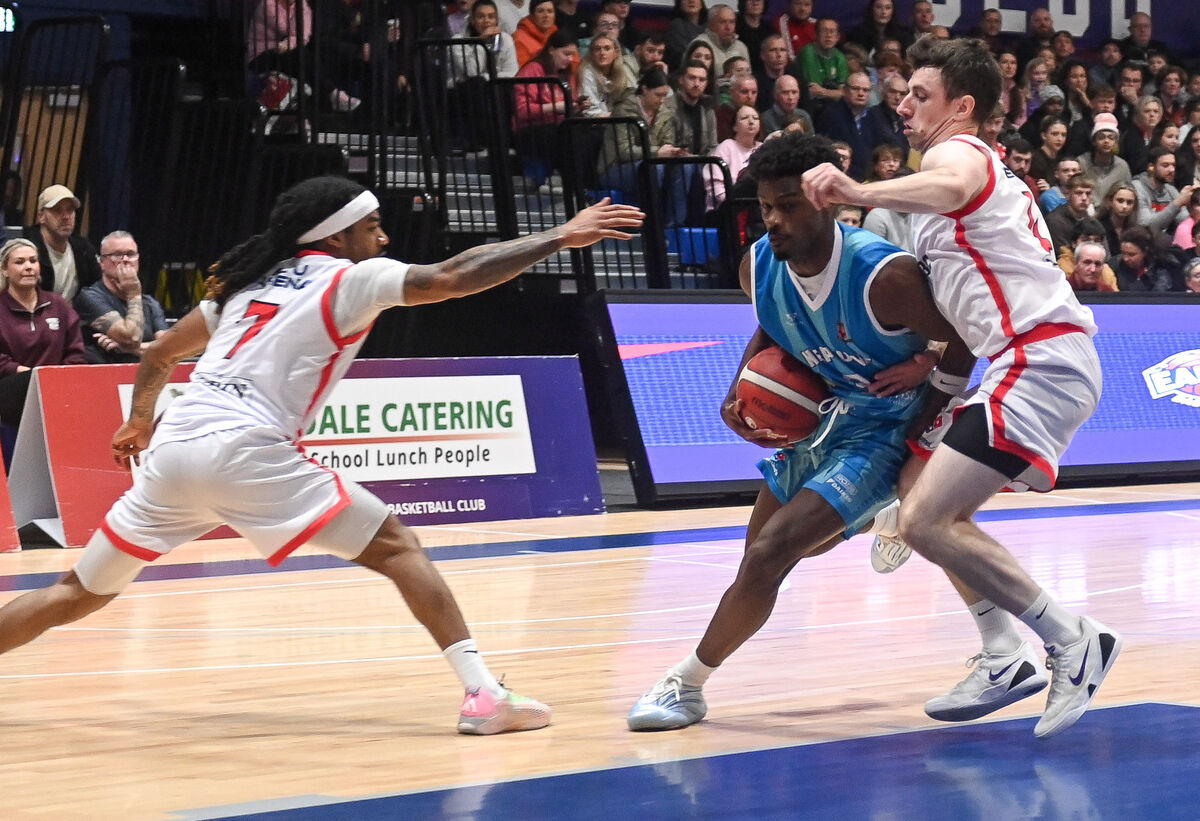 Neptune's Zyon Dobbs drives past Ballincollig's Adrian O'Sullivan and Latrell Jossell during their Men's Super League clash at Neptune Stadium. Neptune's Zyon Dobbs drives past Ballincollig's Adrian O'Sullivan and Latrell Jossell during their Men's Super League clash at Neptune Stadium.