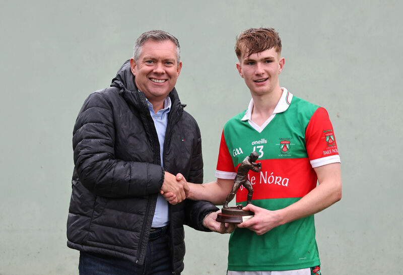 Bryan O'Donovan, MJK Oils presents the Player of the Match trophy to Ben Mayer, Ballinora. 2025 Muskerry Junior A Hurling Championship Final, Ballinora V's Grenagh, at Coachford, Co. Cork. Bryan O'Donovan, MJK Oils presents the Player of the Match trophy to Ben Mayer, Ballinora. 2025 Muskerry Junior A Hurling Championship Final, Ballinora V's Grenagh, at Coachford, Co. Cork.
