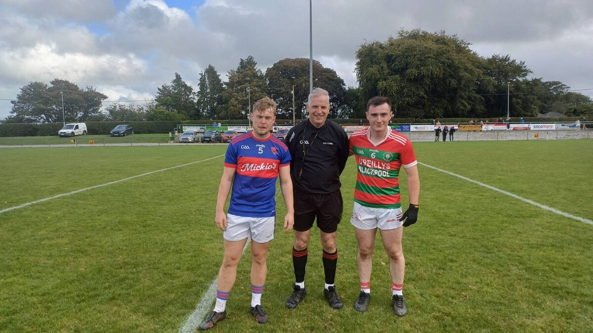 Erin's Own captain Ronan Blackton and Carraig na bhFear captain Tadhg O'Donoghue before the East Cork JAFC group game in Glenville, with referee Willie Wallace. Erin's Own captain Ronan Blackton and Carraig na bhFear captain Tadhg O'Donoghue before the East Cork JAFC group game in Glenville, with referee Willie Wallace.