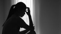 Young  women sitting in dark room feeling pain with life problem.  suffering from husband violence, Stop violence against and se