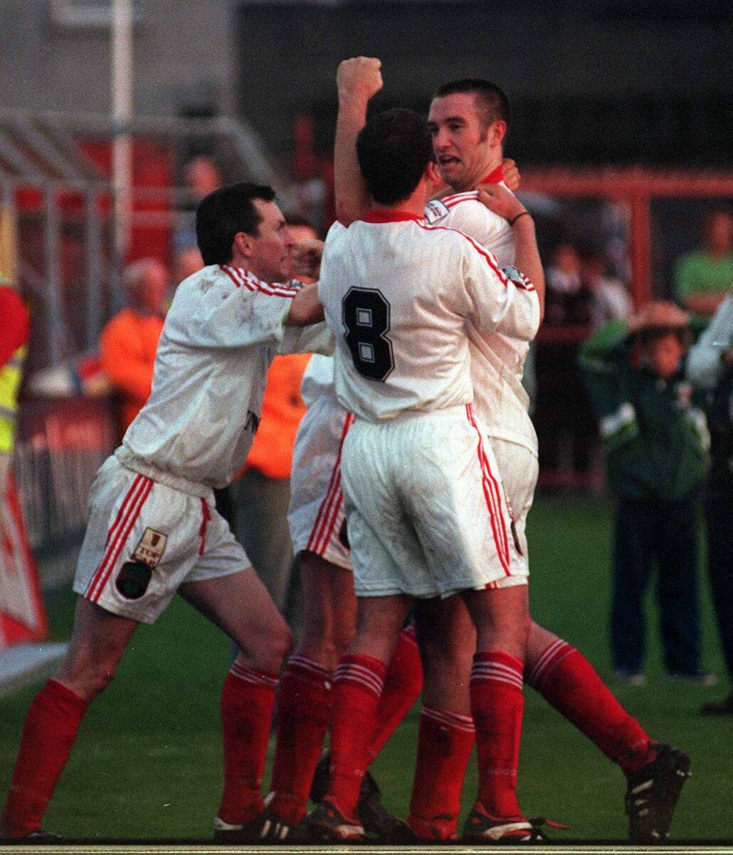 Derek Coughlan is congratulated by teammates as he celebrates scoring the header in the 1998 FAI Cup final replay.