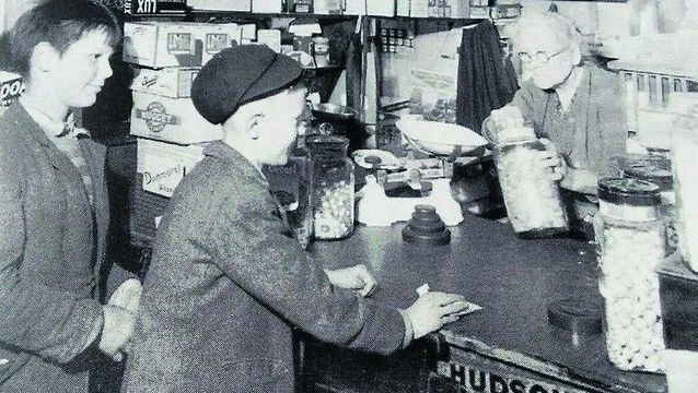 <p>An elderly shopkeeper serving two boys, probably in the 1950s, in a photo sourced in Dungarvan</p> <p>An elderly shopkeeper serving two boys, probably in the 1950s, in a photo sourced in Dungarvan</p>