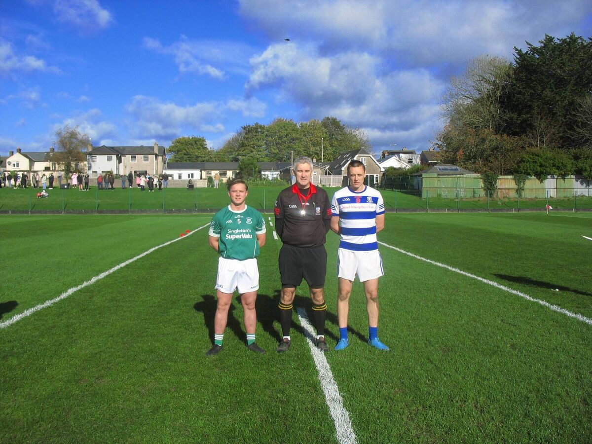 Referee Peter Finnegan accompanied by captains Karl McCarthy (St Vincent's) and Cian O'Brien (Ballyphehane)