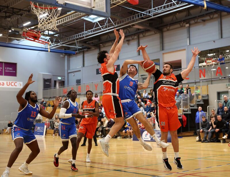 James Hannigan, UCC Demons, battling Andy McGeever and Baptiste Chazelas, Killester. Picture: Jim Coughlan.  James Hannigan, UCC Demons, battling Andy McGeever and Baptiste Chazelas, Killester. Picture: Jim Coughlan.