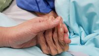 Holding grandmother's hand in the nursing care. Showing all love, empathy, helping and encouragement : healthcare in end of life