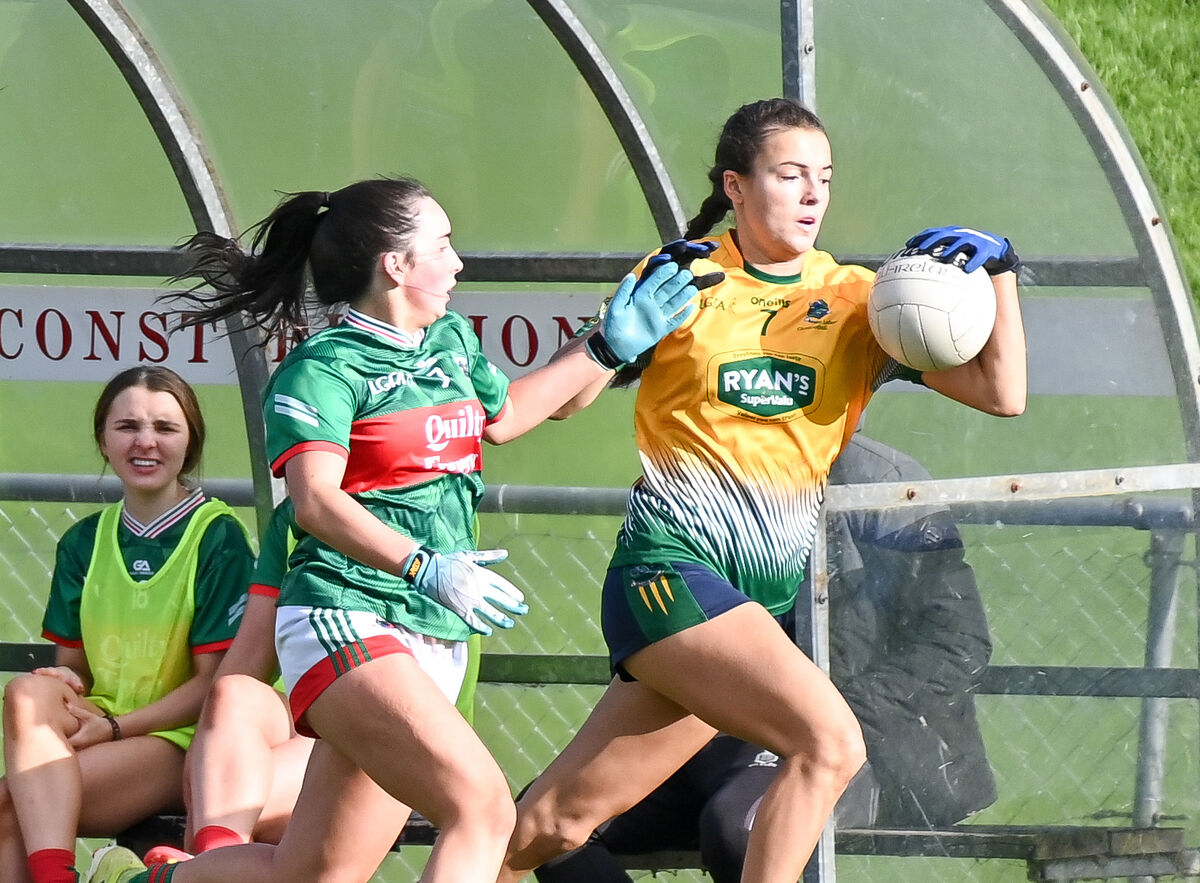  Glanmire's Ava Fitzgerald races past Kilmurry Ibrickane's Keelan Markham. Picture: David Keane.