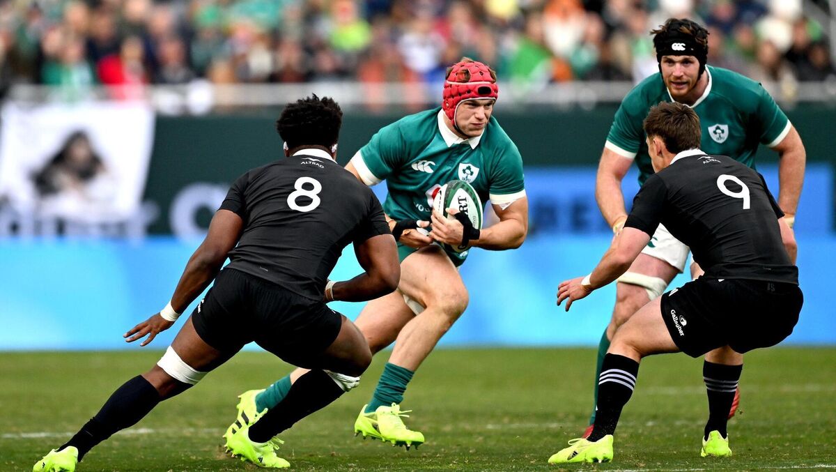 Josh van der Flier of Ireland in action against Peter Lakai, left, and Cam Roigard of New Zealand. Pic: Ramsey Cardy/Sportsfile