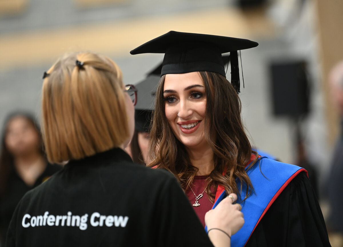  A member of the conferring crew adjusts the gown of Holly Finnerty, from Ballinhassig.