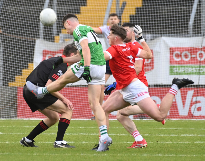 Referee Pa O'Driscoll has to duck as Aghabullogue's Luke Casey shoots from Uibh Laoire's Daniel O'Donovan. Picture: Eddie O'Hare Referee Pa O'Driscoll has to duck as Aghabullogue's Luke Casey shoots from Uibh Laoire's Daniel O'Donovan. Picture: Eddie O'Hare