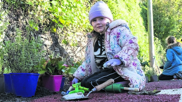 <p>Olivia Pearce, 5, of Lower Glanmire Rd, helping with planting at Railway Park on Grattan Hill, part of the rain garden in the city’s first learn-to-cycle track as part of an exciting project backed by Cork City Council that is now being hailed as a model for other urban neighbourhoods.	Picture: Brian Lougheed</p>