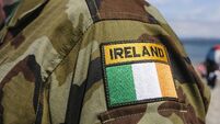 Shoulder patch of a soldier from the Irish Army on camouflaged uniform.