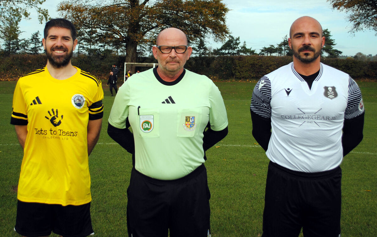 UCC B captain Walter Messina (right), with Blackpool Celtic's Craig Horgan, accompanied by referee Keith Haines. Picture: Barry Peelo.