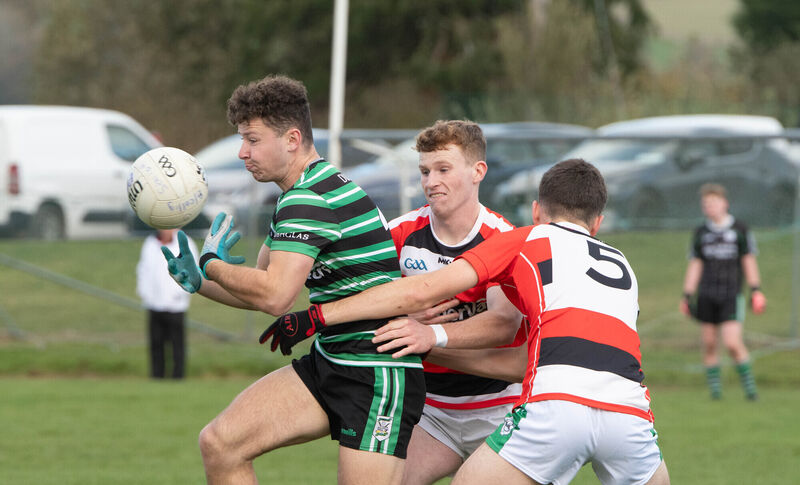 Ollie Barry of Douglas holds on to possession despite the challenges from Ballincollig's Kevin O'Leary and Pete Kelly. Picture: Howard Crowdy