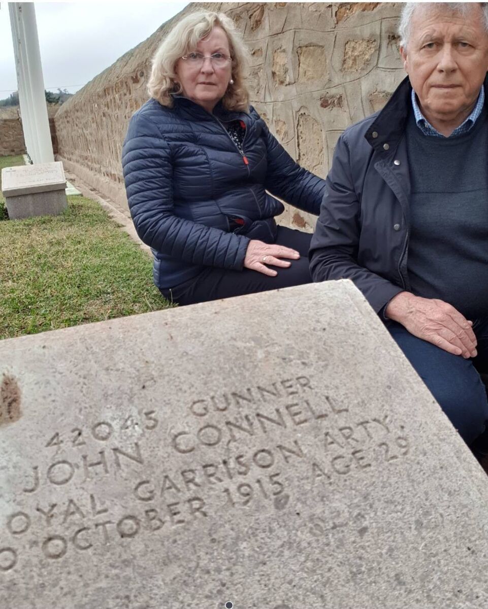 Angela O’Connell with her partner Colin Mackenzie by the grave of her grand-uncle in Portianos Military Cemetery in Greece. Angela O’Connell with her partner Colin Mackenzie by the grave of her grand-uncle in Portianos Military Cemetery in Greece.