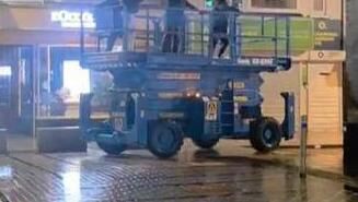 The stolen scissor lift being driven near Oliver Plunkett Street on Sunday.