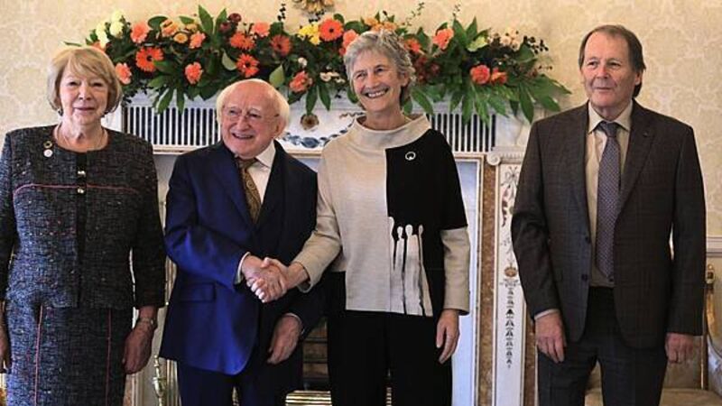 Hugs and handshakes as President Higgins welcomes his successor