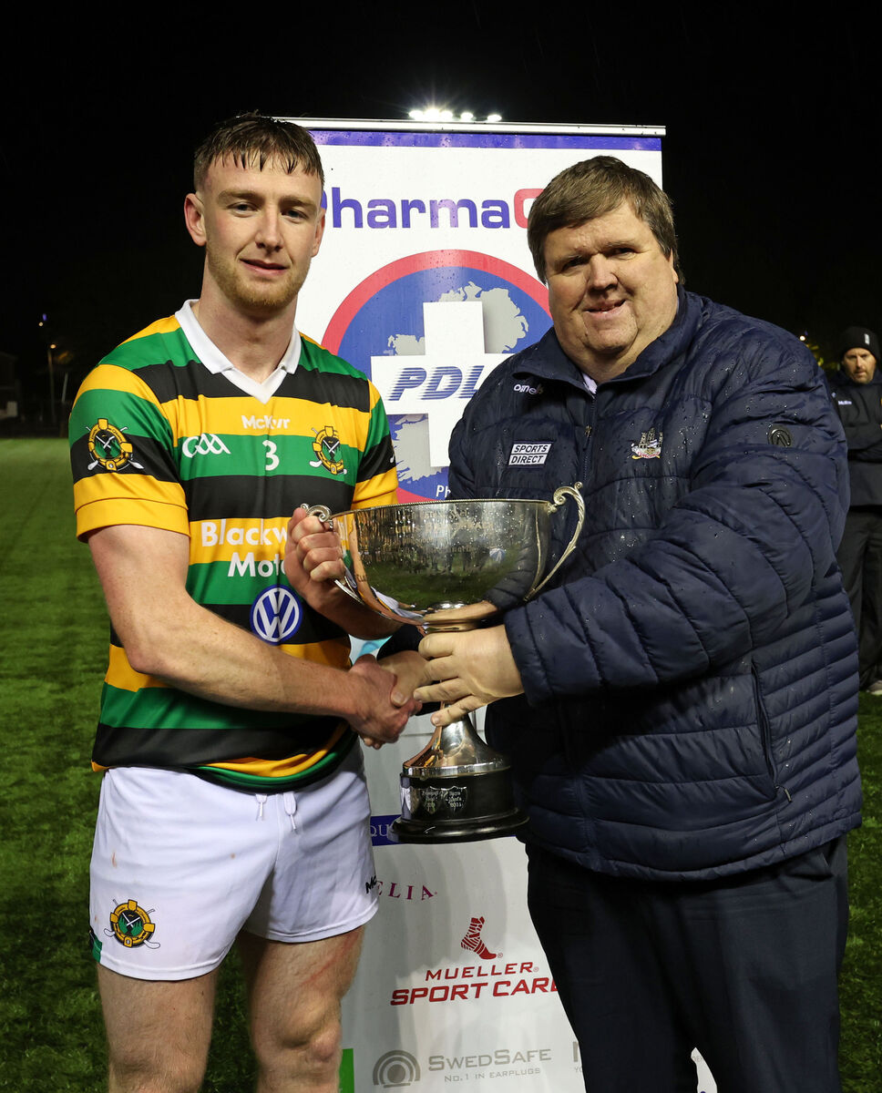 Eoghan Varian receives the Cup from Derek Connolly, Seandún GAA. Picture: Jim Coughlan. Eoghan Varian receives the Cup from Derek Connolly, Seandún GAA. Picture: Jim Coughlan.