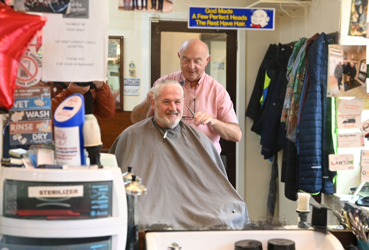 Mick Moriarty (Baldy barber) cutting the hair of customer of 54 years Malcolm Stokes.
