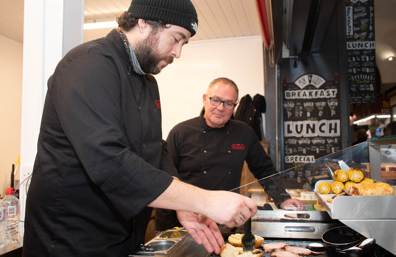 Tom Bradley looks on as Eoin Beville makes a Breakfast bun in their new premises 'On the Hoof' in the English Market.