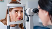 Eye doctor with female patient during an examination in modern clinic
