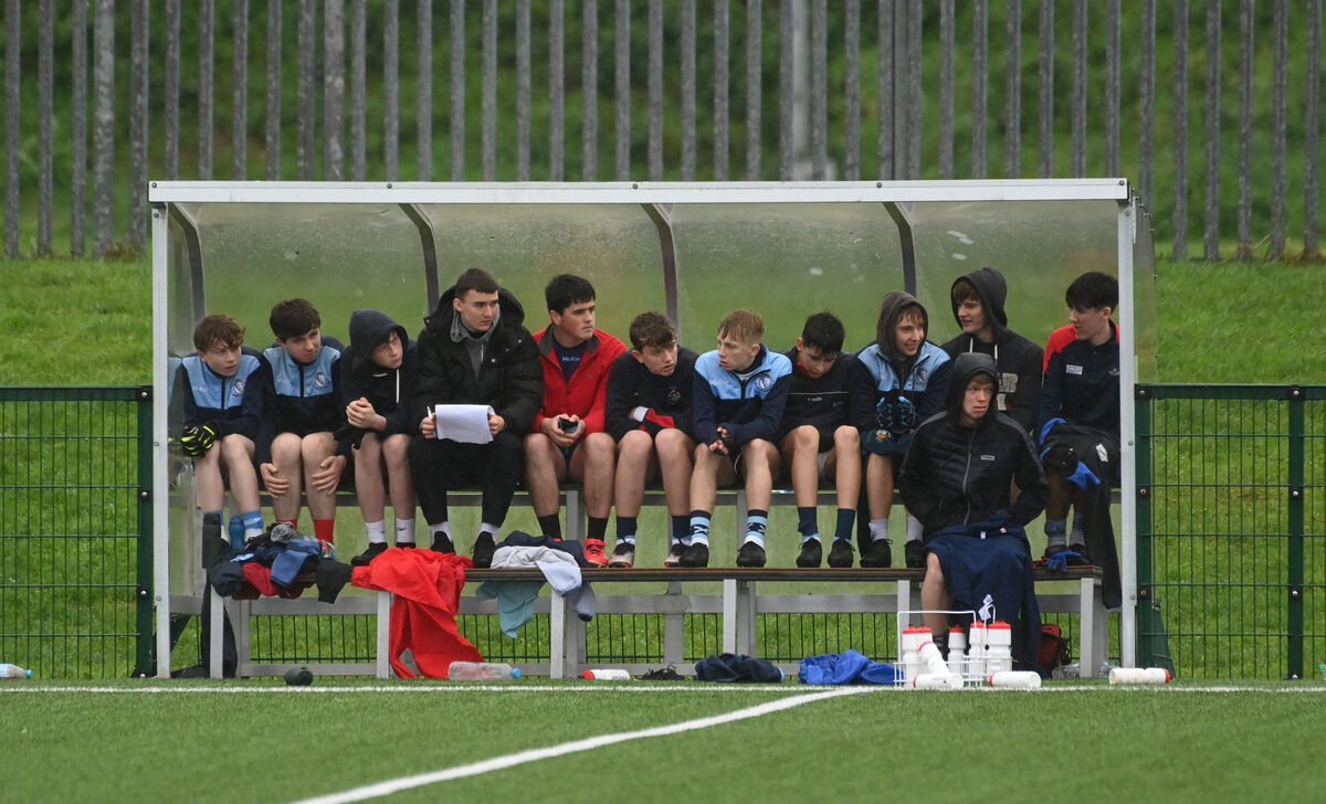 Clonakilty Community College players take shelter from the wind and rain. Picture: Larry Cummins