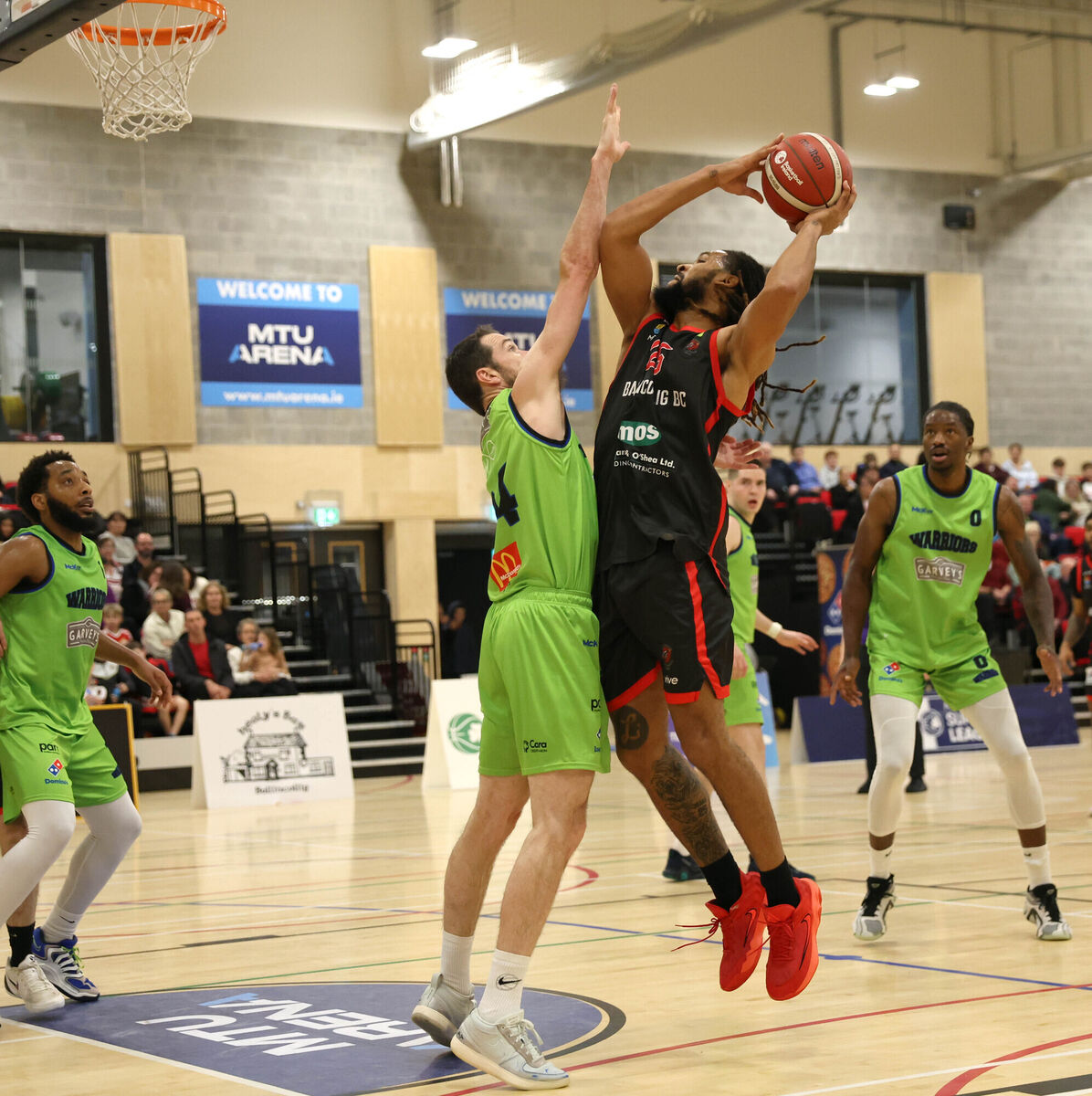  Latavious Mitchell, Ballincollig, rises high with Eoin Quigley, Tralee. Picture: Jim Coughlan.
