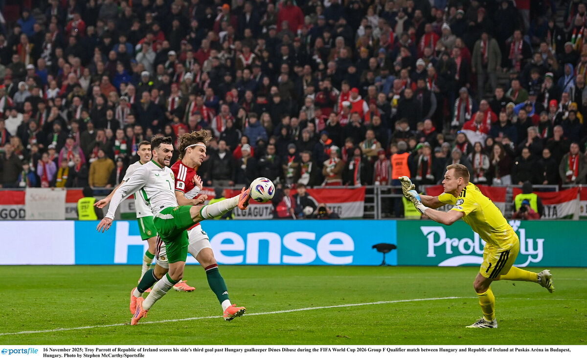 Troy Parrott scores the injury-time winner past Hungary goalkeeper Dénes Dibusz at Puskás Aréna in Budapest. Picture: Stephen McCarthy/Sportsfile