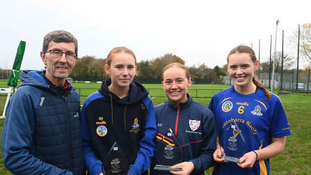 <p>Rory Noonan, The Echo,  presents the monthly award to sisters Kate, Orlaith, and Meabh Cahalane of St Finbarr's Camogie Club and Éire Óg Ladies Football Club. Picture: Larry Cummins</p>