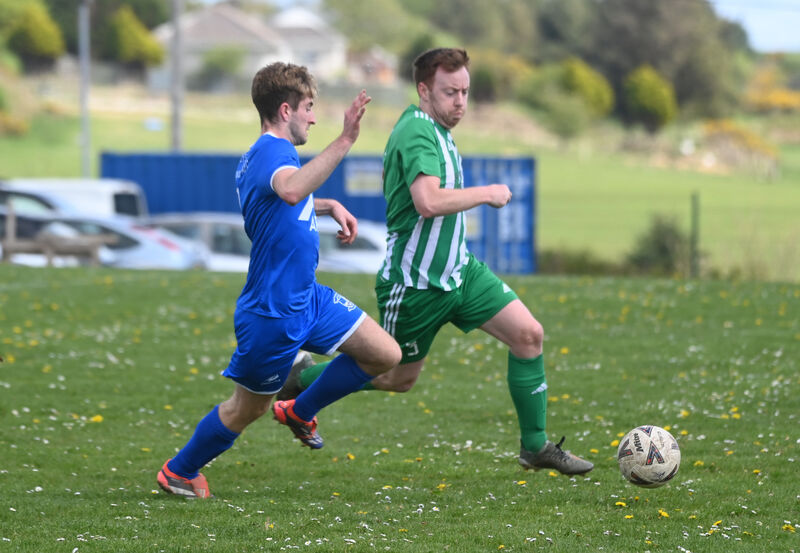 Colm Madden, Ballinhassig AFC, chases Passage defender Eamonn Fitzgerald in a game last season. Picture: Larry Cummins Colm Madden, Ballinhassig AFC, chases Passage defender Eamonn Fitzgerald in a game last season. Picture: Larry Cummins