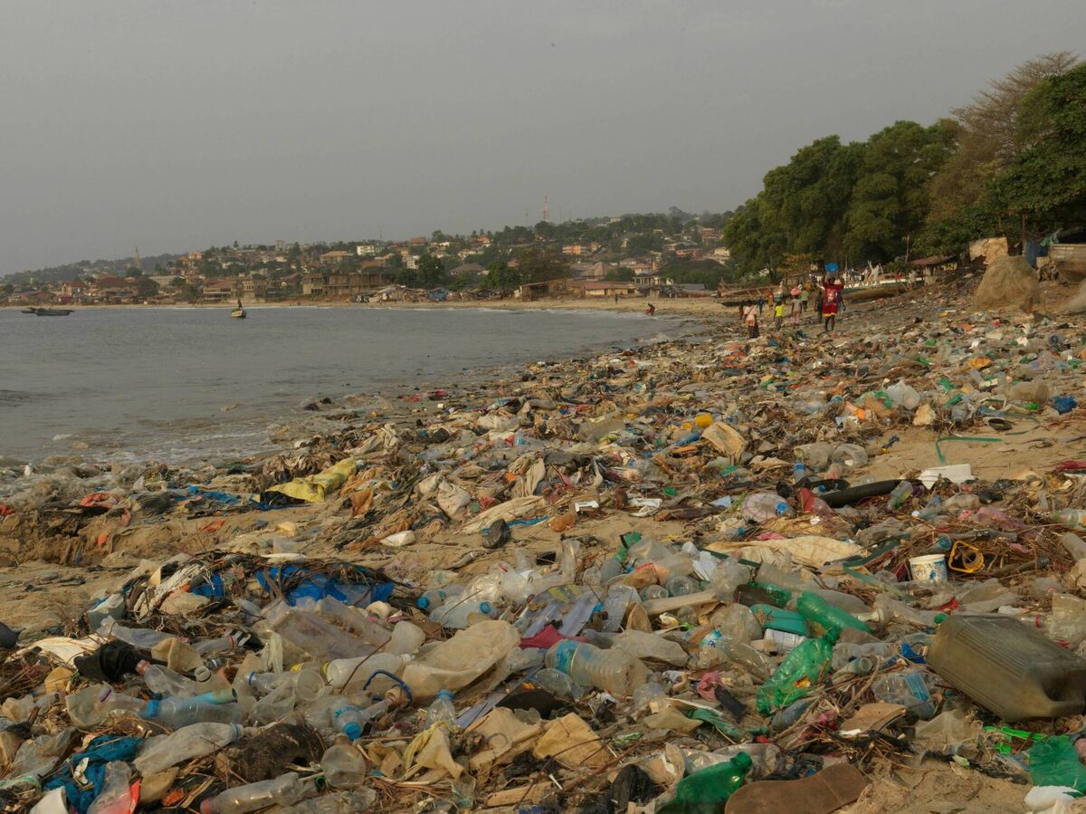 Plastic waste blankets a Freetown beach, washed in from the city’s drains and swept in by the tide. For coastal communities, the ocean is a lifeline critically threatened by pollution and climate change. Photograph: Peter Caton for GOAL Global