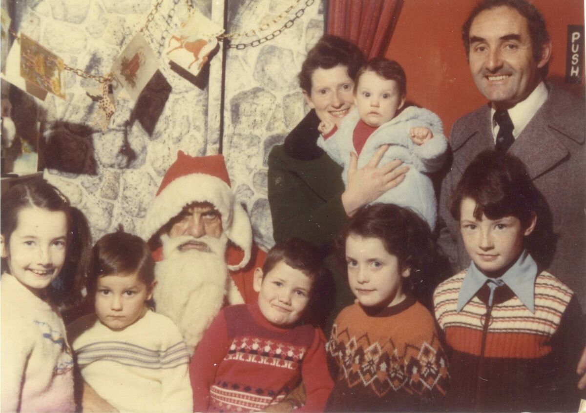 The Casey family visiting Santa; Catríona, John, Pat, Bernadette, Brid, their mum Bridie holding baby Caroline, and dad, Pat