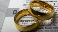 Divorce concept. Law and Justice background. Judge gavel on with two golden wedding rings