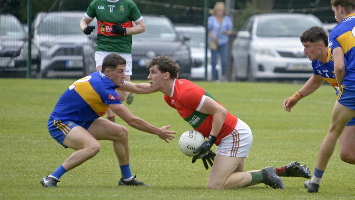 Clonakilty's Mark White is tackled by Carrigaline's Kieran McCarthy. Picture: Denis Boyle
