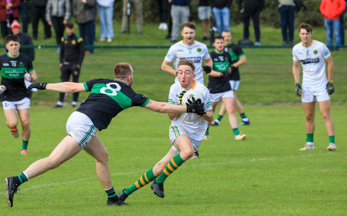 St Michael's Adam Hennessy tries to avoid a tackle from Nemo's Alan O'Donovan during their PSFC clash at Shanbally. Picture: David Creedon