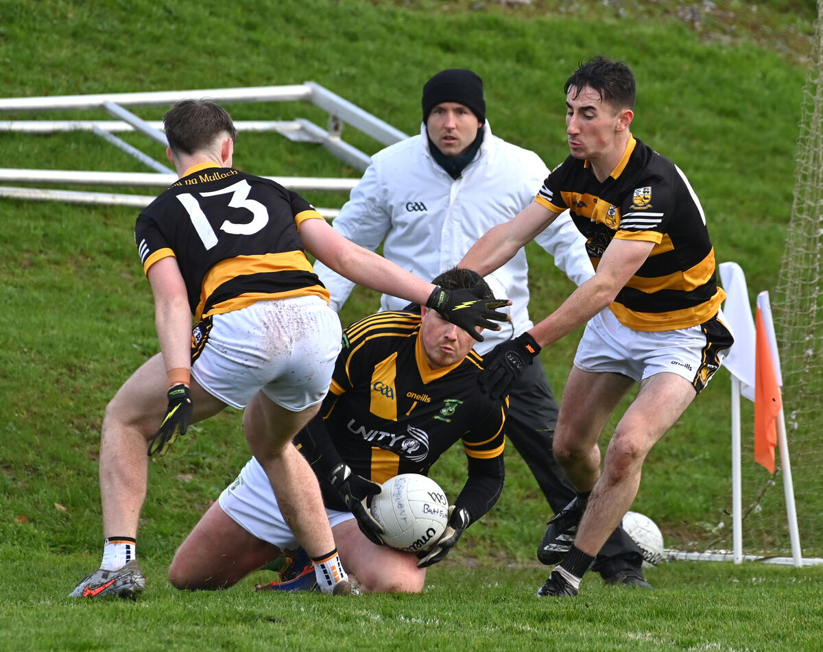  Buttevant players David Hanlon and Aaron Trimm putting pressure on Ahane keeper Tristan O'Sullivan. Picture: Dan Linehan