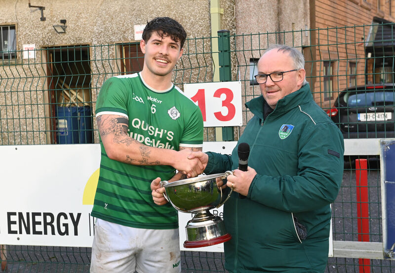  Ballincollig captain James Dwyer is presented with the Jerry Dineen Memorial Trophy by Miah Moynihan, Muskerry Division. Picture: Larry Cummins