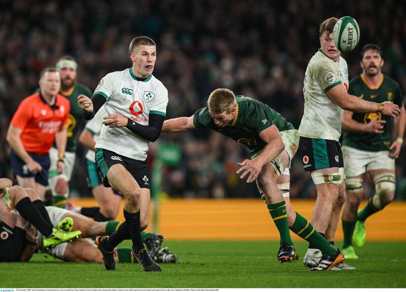 Sam Prendergast of Ireland passes as he is tackled by Pieter-Steph du Toit of South Africa. Picture: Brendan Moran/Sportsfile
