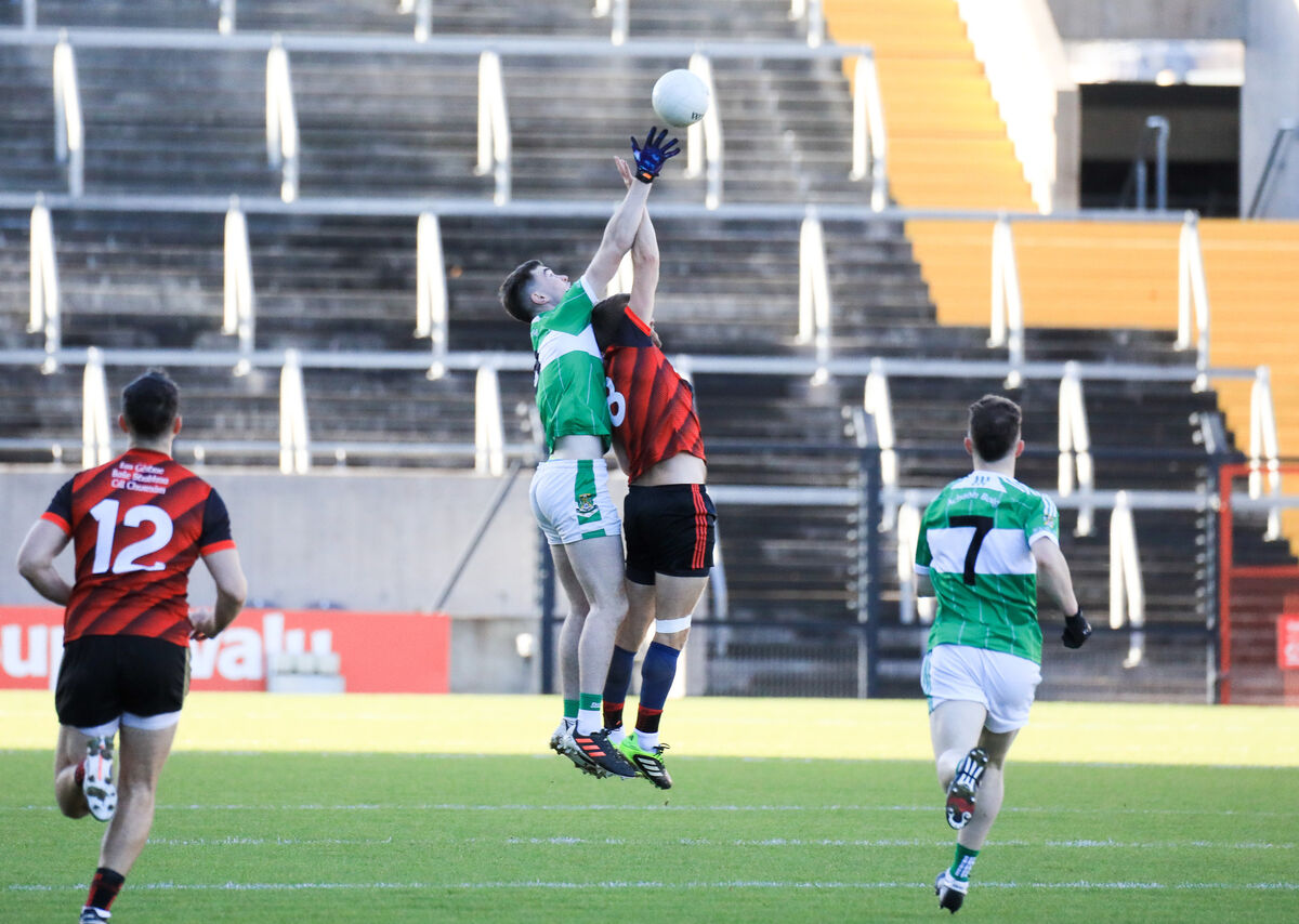 Aghabullogue's Colm Gillespie and Askeaton's Shane Gallagher rise for the dropping ball. Picture: David Creedon