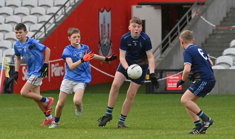 Seán Hennessy, Scoil Oilibheir, getting his pass away to Aaron Gayfer watched by Glasheen players Conor Kidney and Michael Cotter. Picture Dan Linehan Seán Hennessy, Scoil Oilibheir, getting his pass away to Aaron Gayfer watched by Glasheen players Conor Kidney and Michael Cotter. Picture Dan Linehan