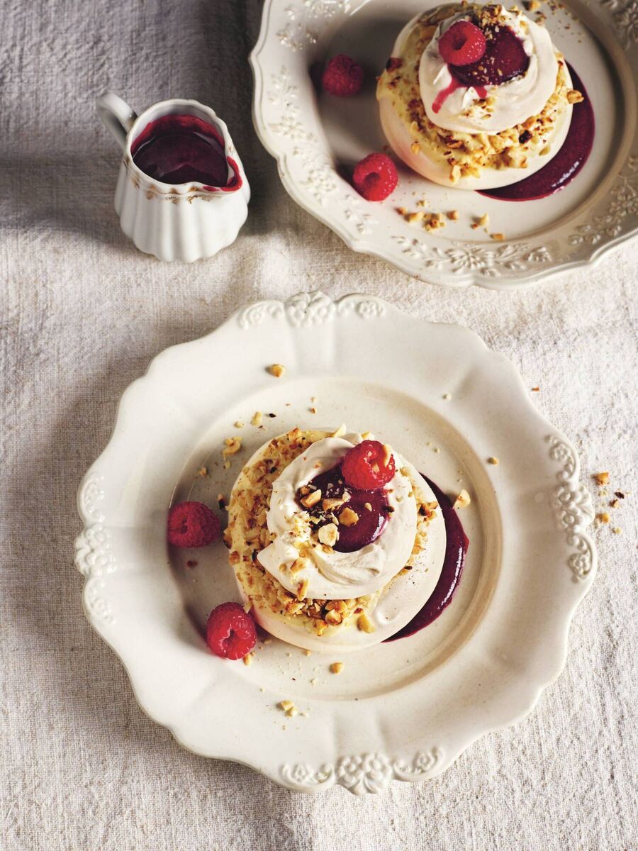 Rick Stein's hazelnut pavlovas with white chocolate and dark berry sauce. Picture: James Murphy/PA